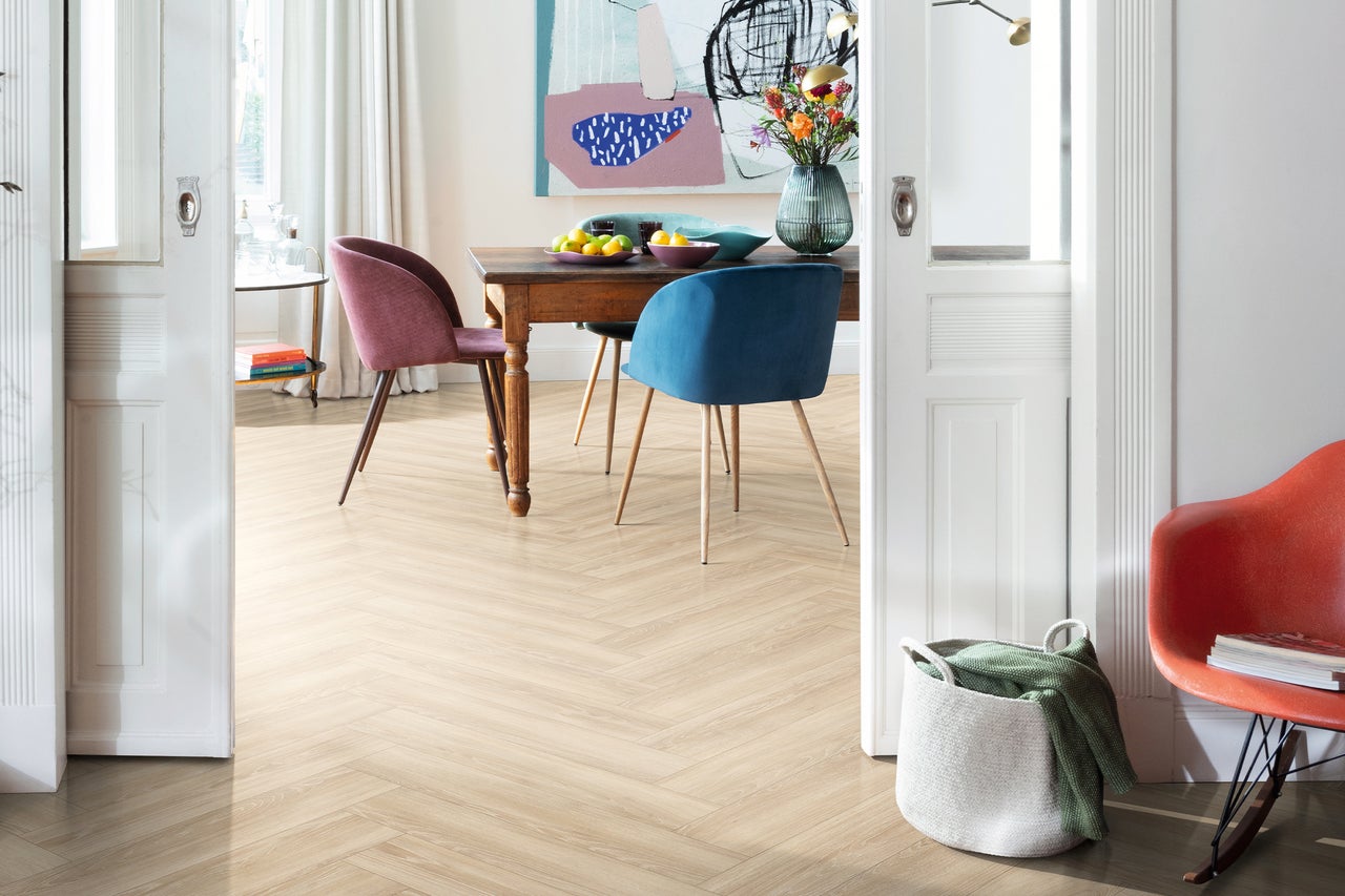 Eetkamer met houten tafel, stoelen en lichte visgraatparketvloer