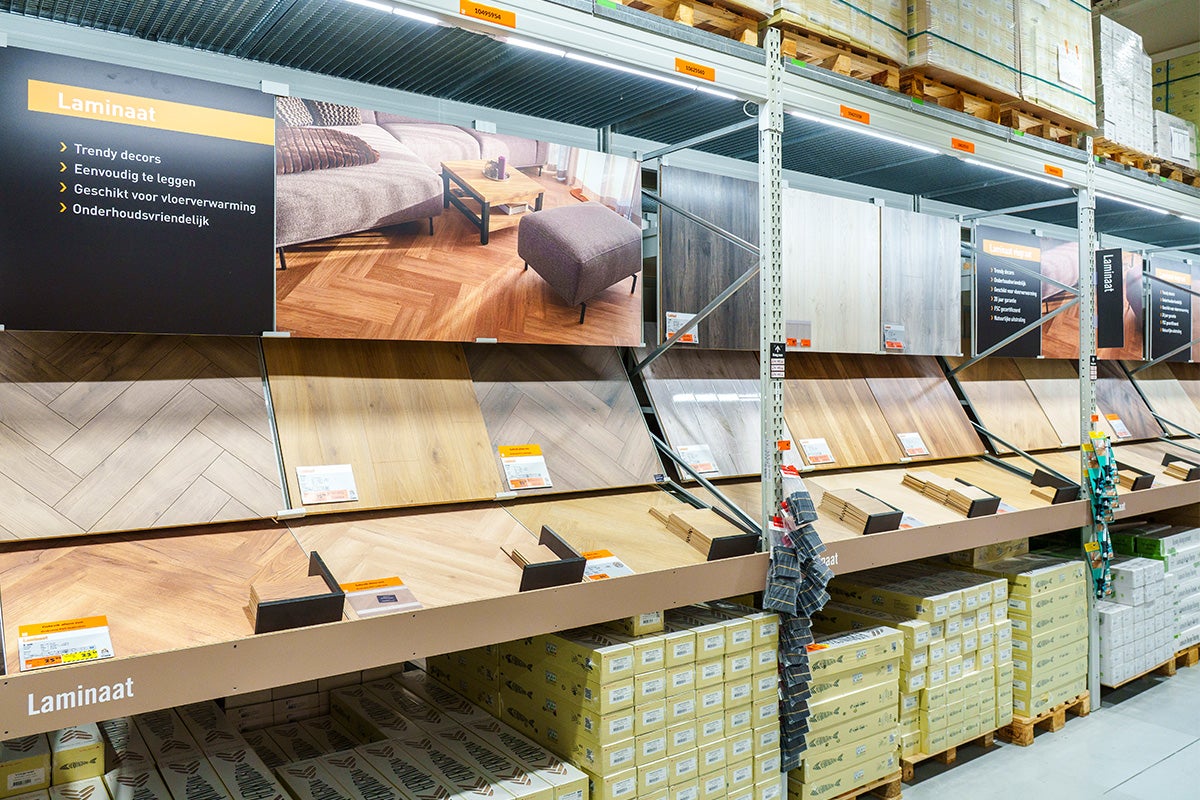Overzichtelijke presentatie van laminaatvloeren met diverse houtdecors zoals visgraat en planken, inclusief monsterborden en voorraad.