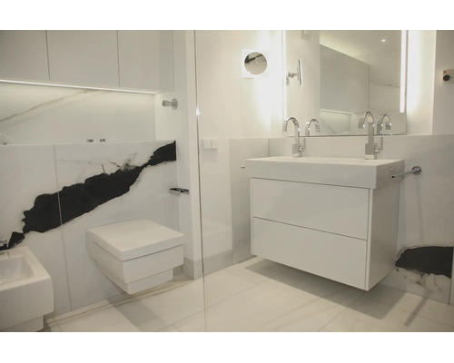 Moderne badkamer met hangend wastafelmeubel, wandcloset, bidet en grote tegels met een opvallend zwart aderpatroon.