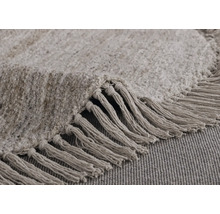 Detailopname van een rond vloerkleed met franjes
