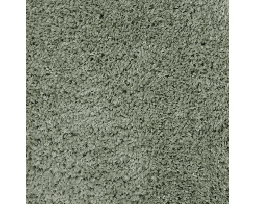 Close-up van een groen shaggy tapijt.