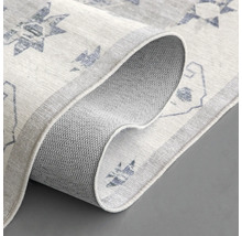 Detailopname van een vloerkleed met motief en antislip onderkant