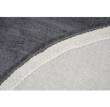 Detailopname van een grijs tapijt met textielen rug