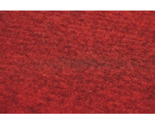 Detailopname van de textuur van een rood naaldvilt tapijt.