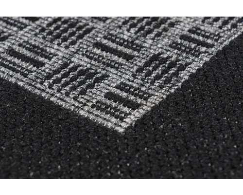 Detailopname van een zwart tapijt met grijs zigzagpatroon