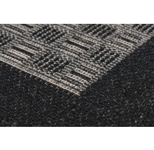 Detailopname van een tapijt met een geometrisch patroon