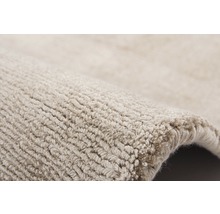 Detailopname van een beige tapijt met structuur
