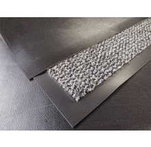 Close-up van een schoonloopmat met textieloppervlak en randafwerking
