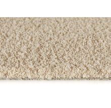 Close-up van een beige tapijt met lussenstructuur