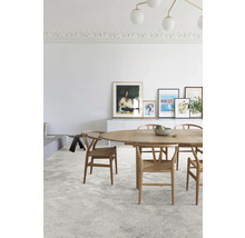Lichte ruimte met eettafel, stoelen en decoratieve elementen.
