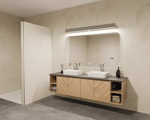 Badkamer met dubbele wastafel, spiegel, verlichting en douchecabine