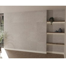 Moderne woonkamer met wandpanelen in steenlook, visgraatparket en verlichte ingebouwde houten planken.