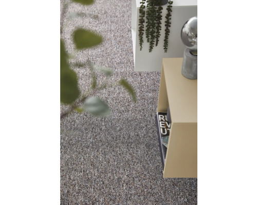 Gestructureerd tapijt in een modern ingerichte woonruimte met bijzettafel en plant.