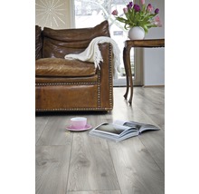 Woonkamer met laminaatvloer, bank, tafel en decoratie