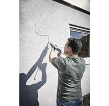 Man dicht een scheur in een muur af met een kitpistool.