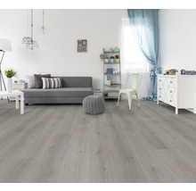 Woonkamer met lichte houten vloer, bank, commode en decoratie