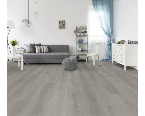 Woonkamer met lichte houten vloer, bank, commode en decoratie