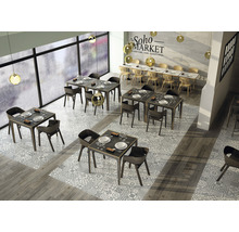 Interieurfoto van een restaurant met tafels, stoelen en vloertegels in een patroondesign.