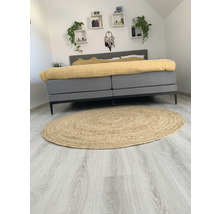 Slaapkamer met bed, wandplanken en rond vloerkleed