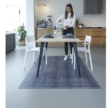 Lichte eetkamer met eettafel, stoelen en donkergrijs vloerkleed