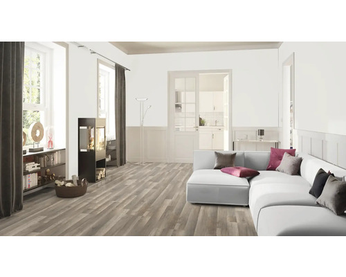 Woonkamer met houten vloer, bank en houtkachel