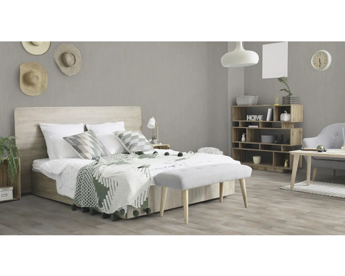 Lichte slaapkamer met bed, houten rek en bank