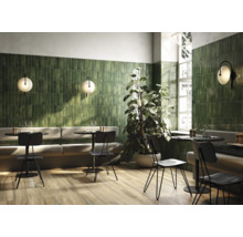 Restaurant met groene wandtegels en houten vloer