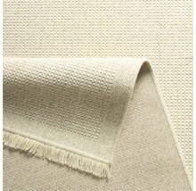 Detailweergave van een beige tapijt met franjes