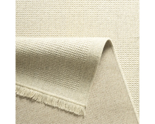 Detailweergave van een beige tapijt met franjes