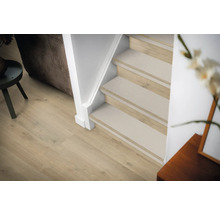 Interieurfoto van een trappenhuis met houten treden en trapmatten