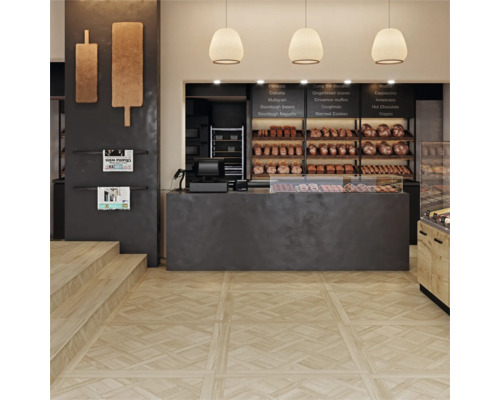 Moderne bakkerij met lichte vloertegels in houtlook met decoratief parketpatroon en een donkere verkoopbalie.