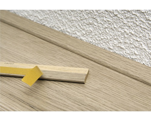 Houten plint met plakband voor montage aan de muur