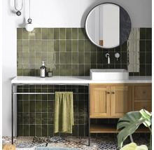 Moderne badkamer met groene tegels, wastafel, spiegel en handdoekenrek