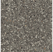 Close-up van een vloertegel met terrazzo-uitstraling.