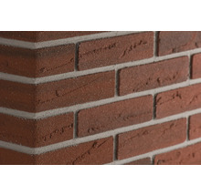 Close-up van een bakstenen muur met grijze voegen