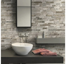 Badkamer met wastafel, spiegel en wandbekleding in steenlook